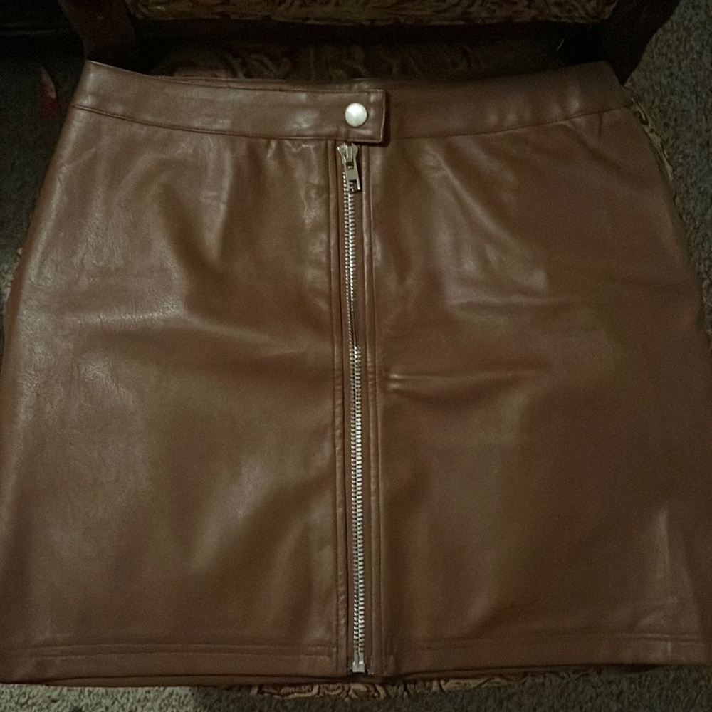 Very nice brown mini skirt looks like leather but not